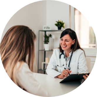 A doctor attentively listening to a woman, showcasing the personalized care provided during QT imaging at DeteQTion.